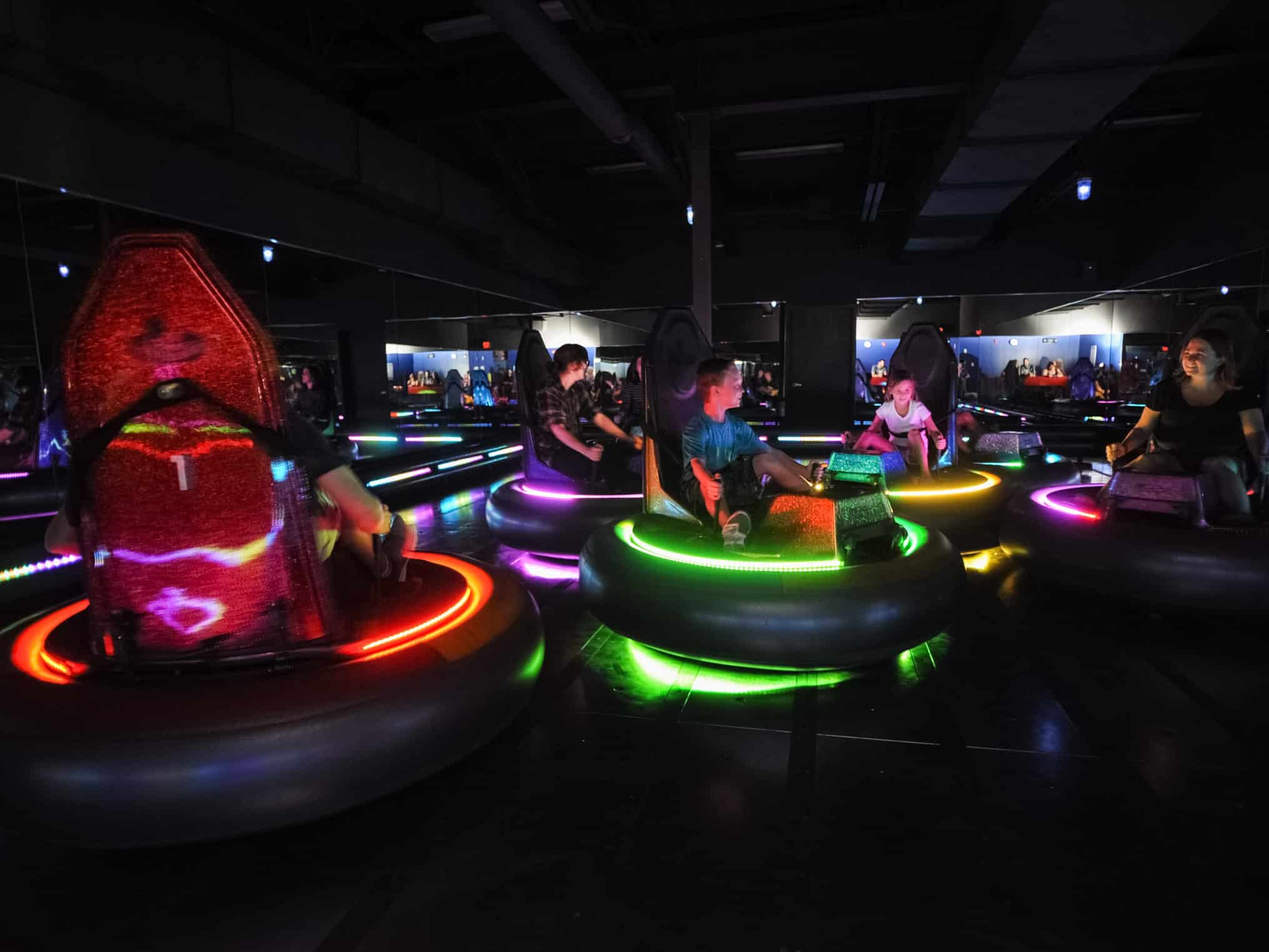 Adults and kids riding bumper cars