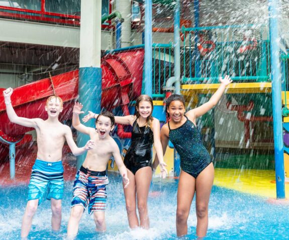 Four young friends in the aquaplay area