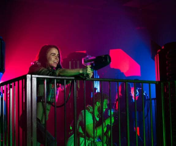 Woman shooting in laser tag