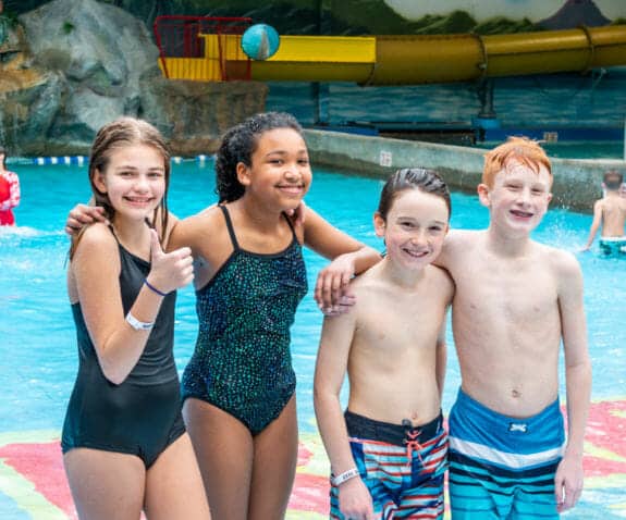 Group of young kids standing together in the raptor reef wave pool