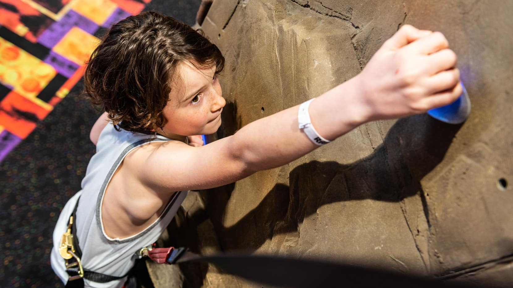 Young boy rock climbing