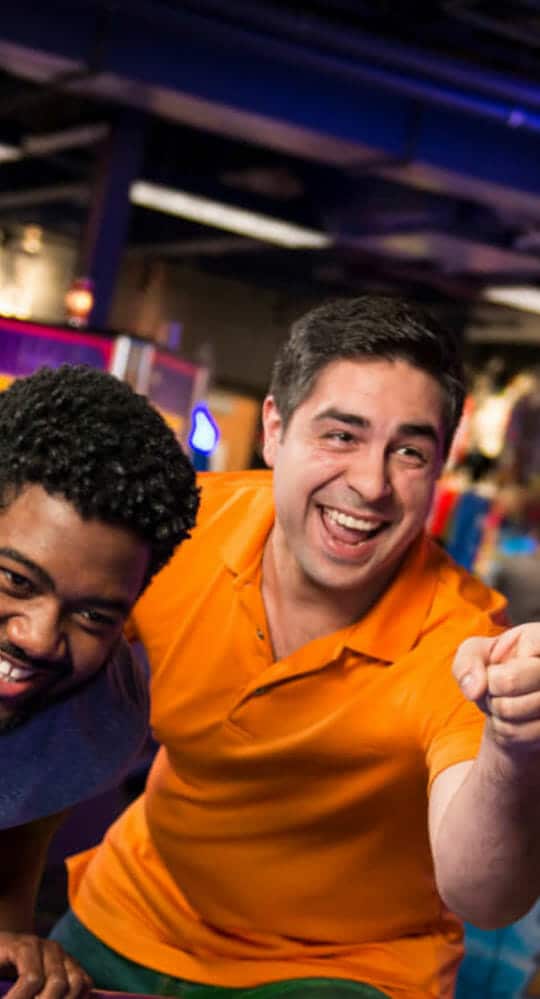 Adults playing air hockey