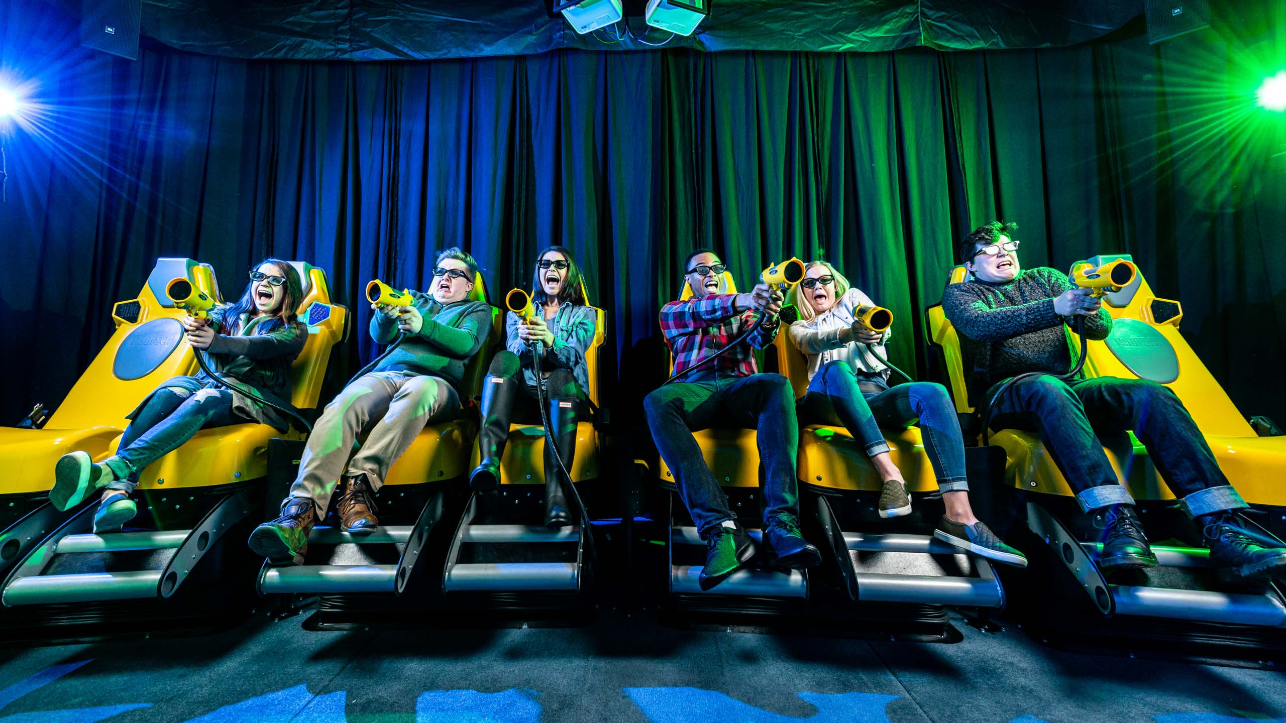 Group of young adults all on the XD Dark ride